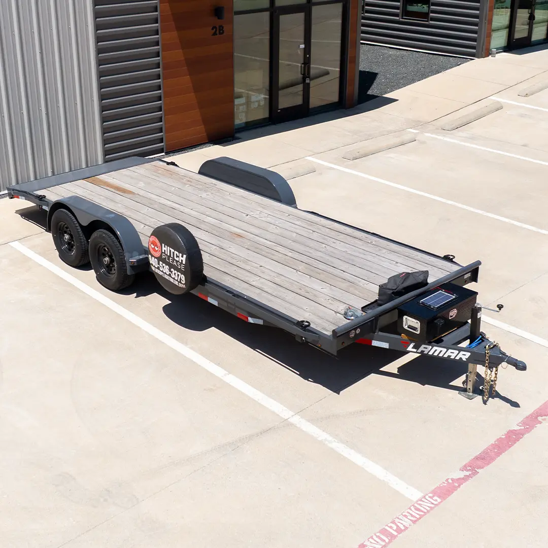 Lamar 20-foot dovetail car and truck hauler with treated wood deck, parked and ready to rent in Krugerville, North Texas